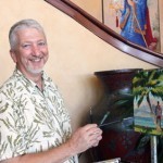 Artist Mike Carroll working on a painting at Four Seasons Manele Bay.