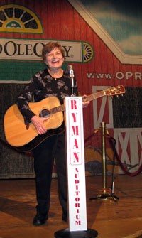The author poses-on-Ryman-Auditorium-stage