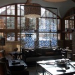 The sunny lobby of The Sebastian features high ceilings, rustic-but-classy Colorado mountain style decor and a double-sided fireplace (not shown).