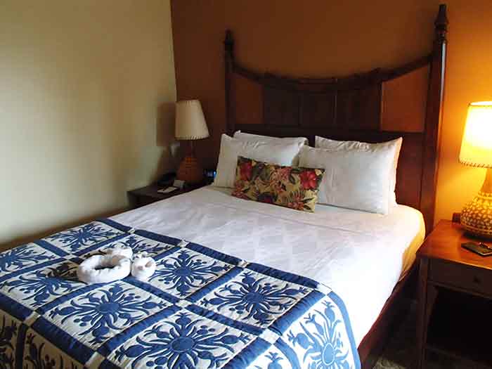 Rooms are decorated in a classy tropical theme. Can you spot the Hidden Mickeys in the quilt?